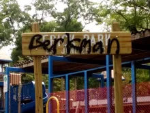A sign for Frick Park tagged with "Berkman"