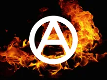 Anarchist circle-a with flames in the background